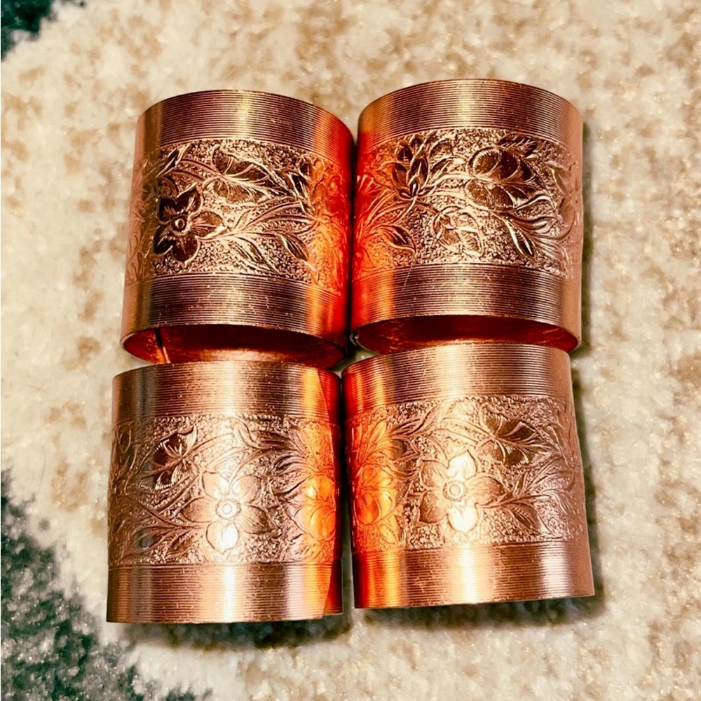 vintage 1977 coppercraft 4 copper flower engraved napkin rings. Good condition.